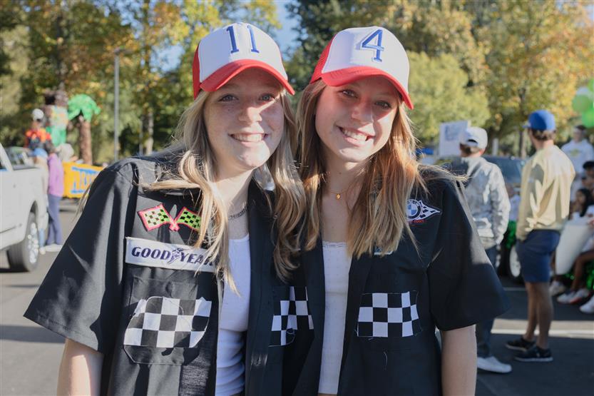 Two students smile